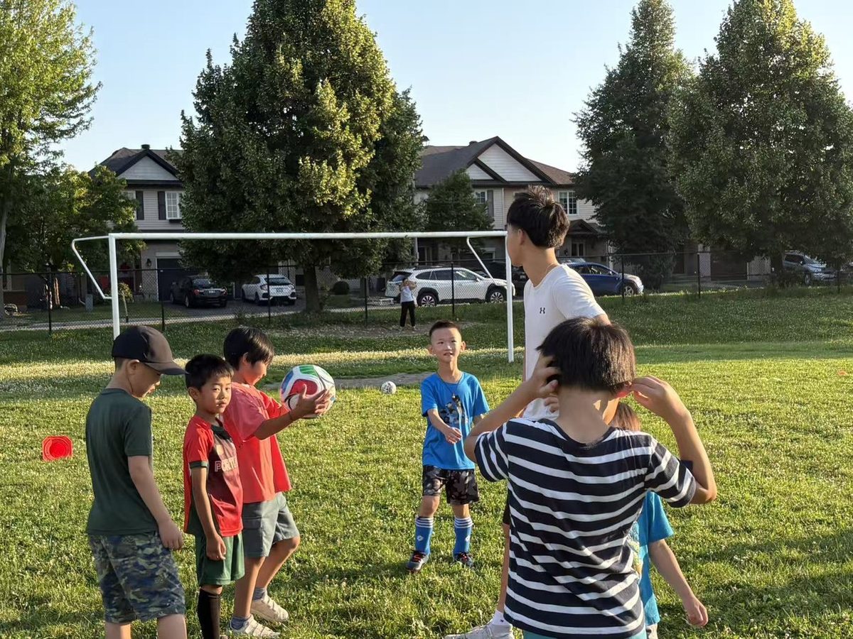 A coach leading children through passing drills