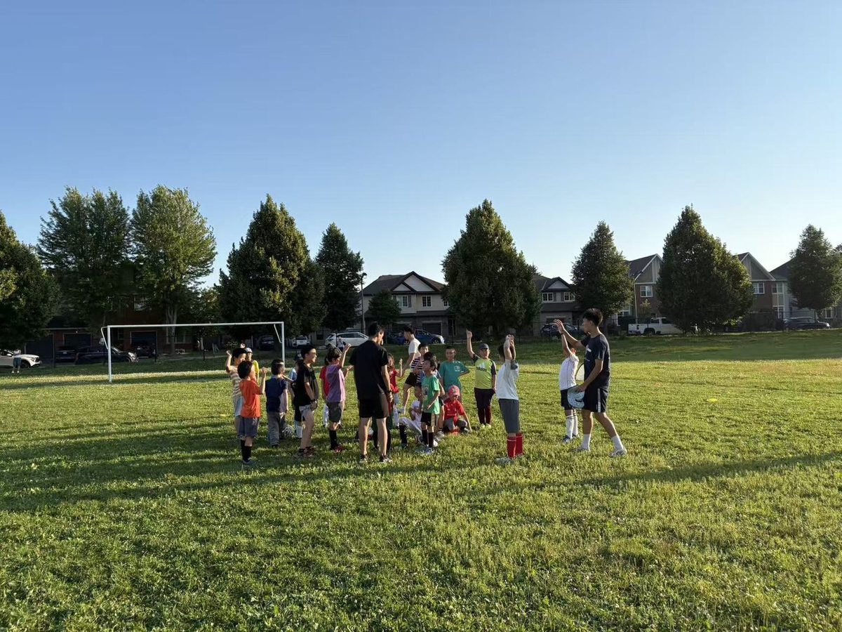 Soccer coaches guiding young players during training