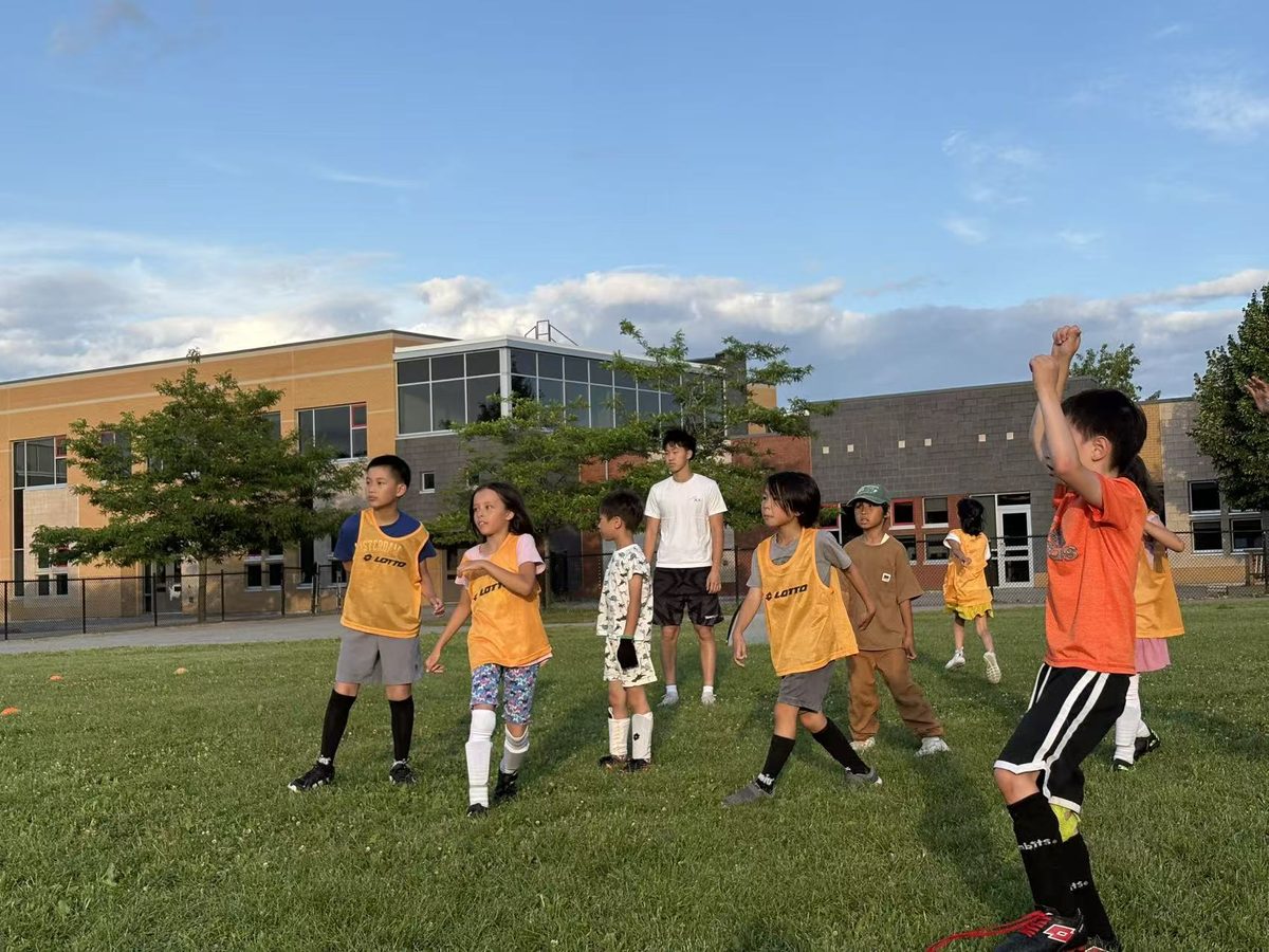 Children participating in a coach-led soccer exercise