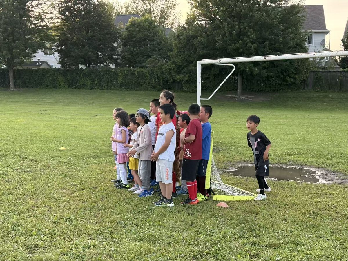 Young soccer players gathering beside the goal