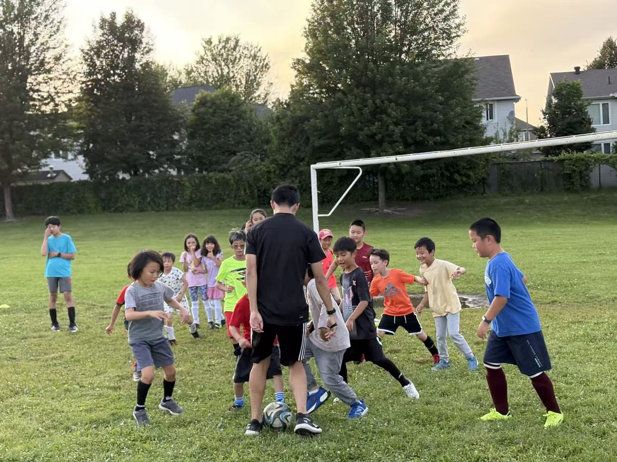 A coach leading the children through warm-up activities